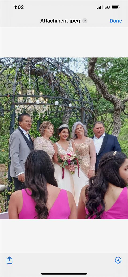A group of people standing in front of a metal arch