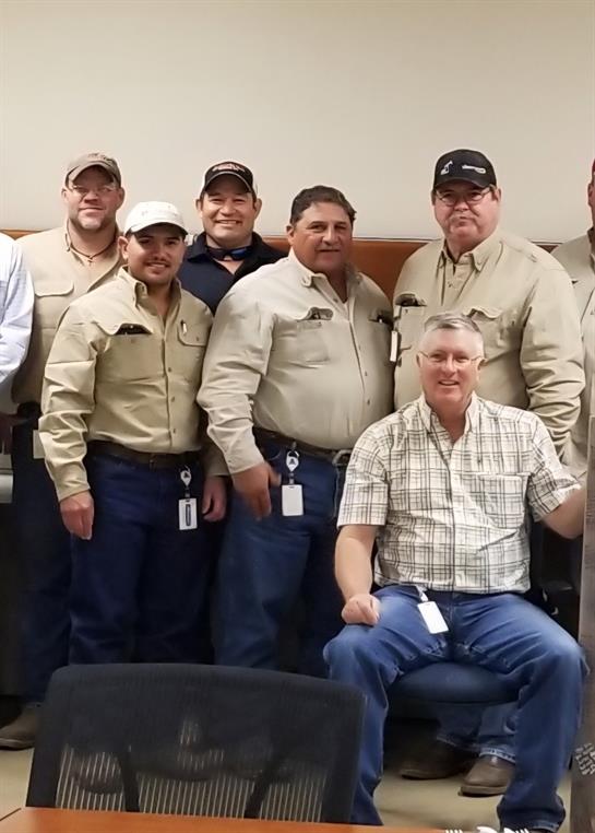A group of men posing for a photo