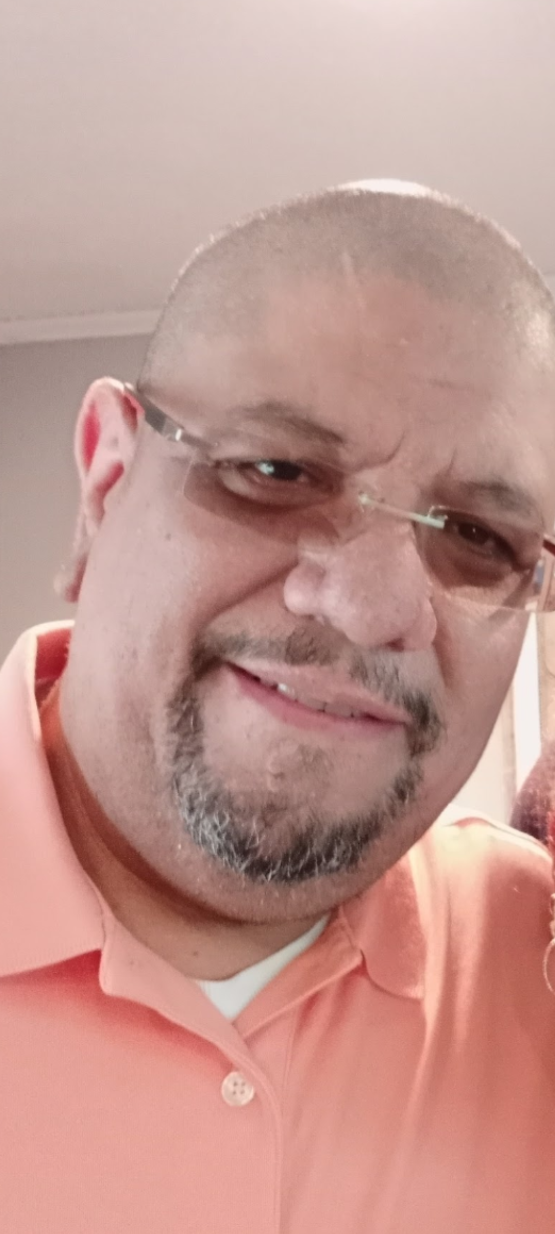 Two friends smiling and enjoying a lighthearted moment at a casual indoor gathering.