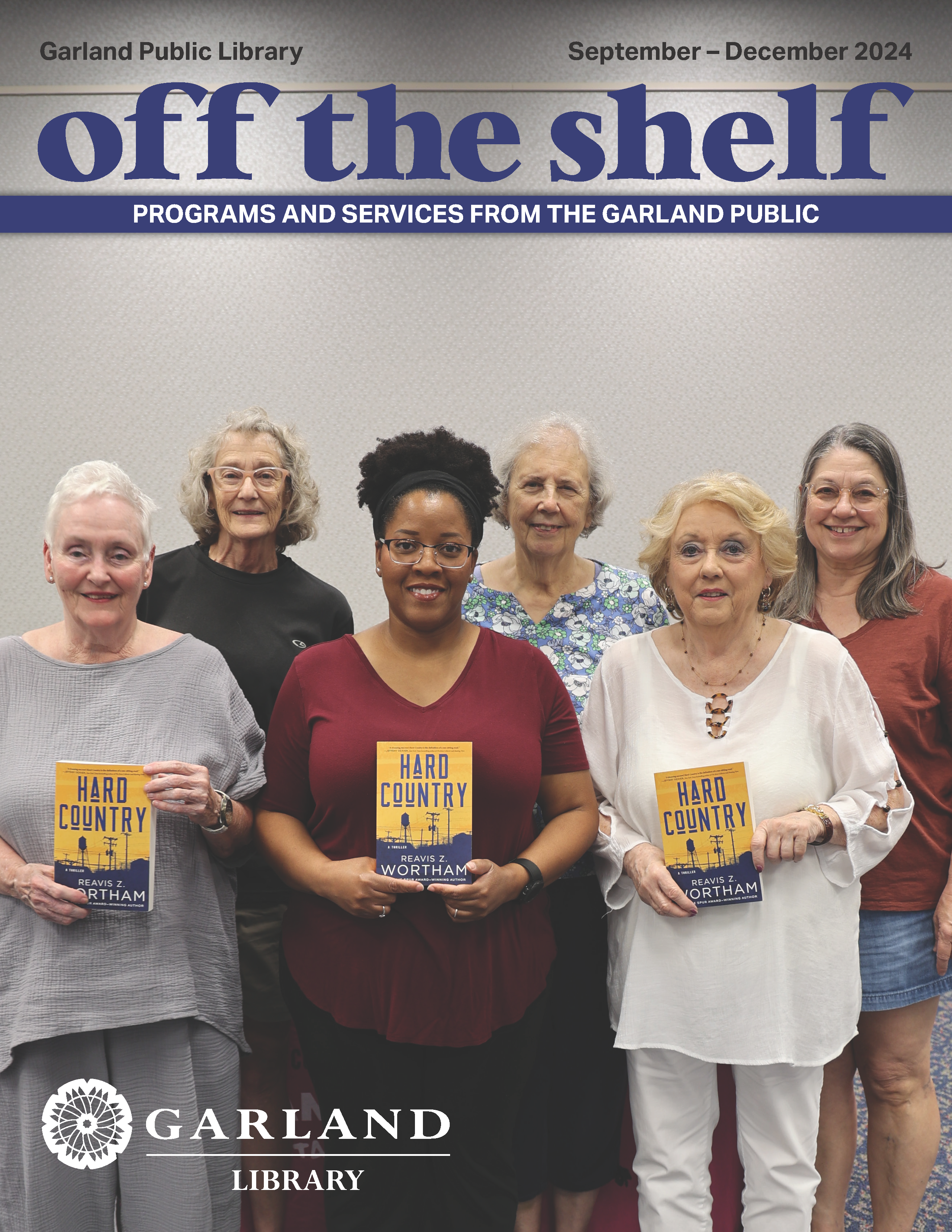 Local readers pose together at Garland Public Library showcasing their newly acquired books.
