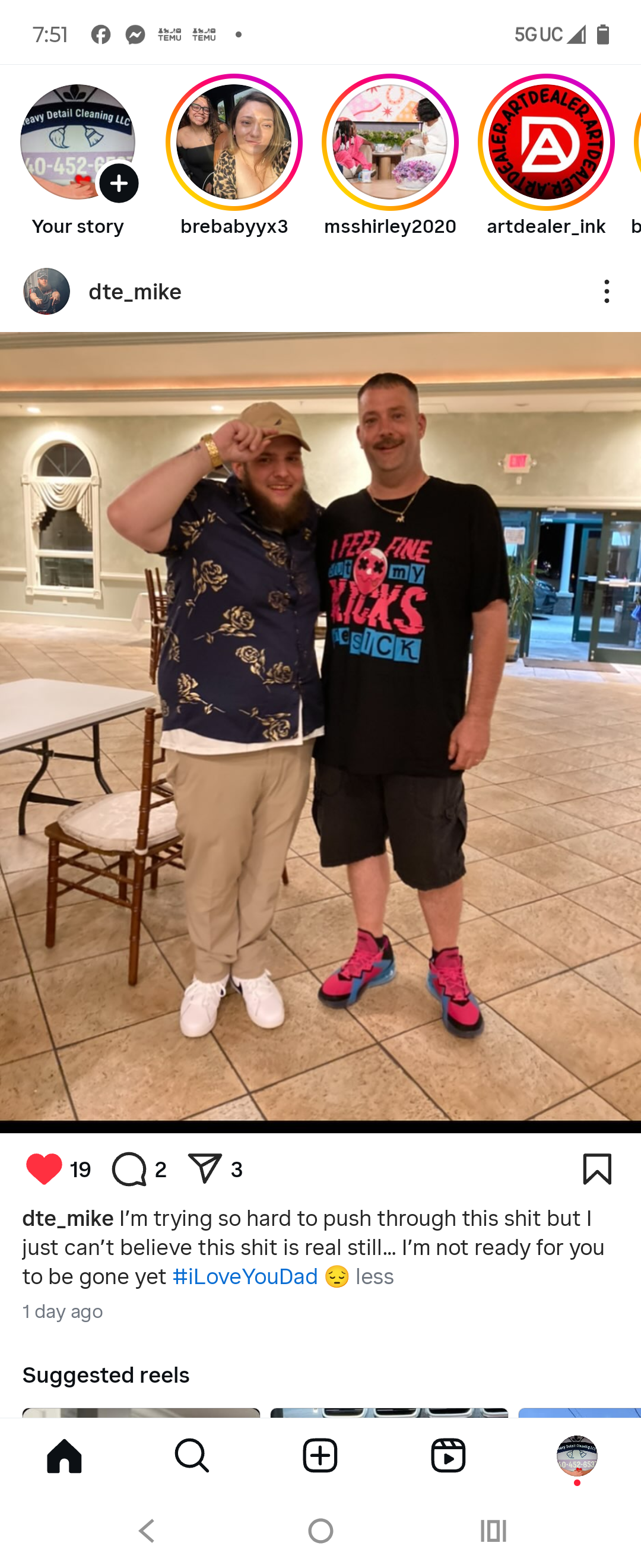 Two friends smile warmly at each other in a community center during a gathering at night.