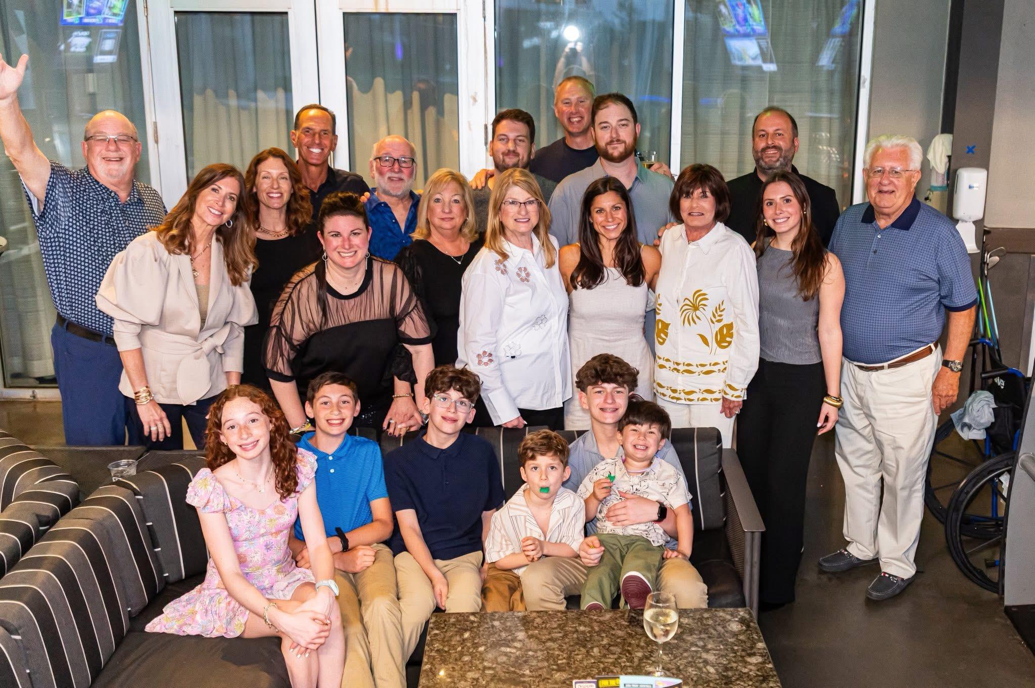 A joyful gathering of family and friends enjoying a reunion in a lively modern venue at night.