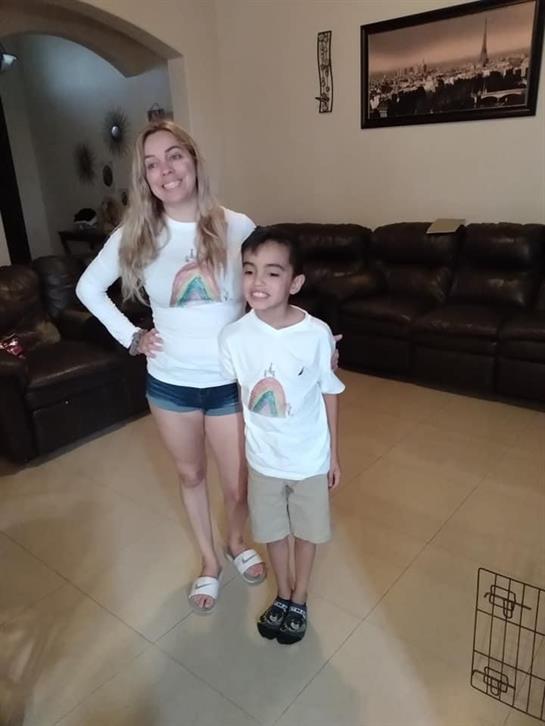 A woman and a boy posing for a picture