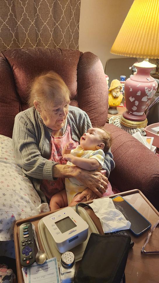 An old woman holding a baby