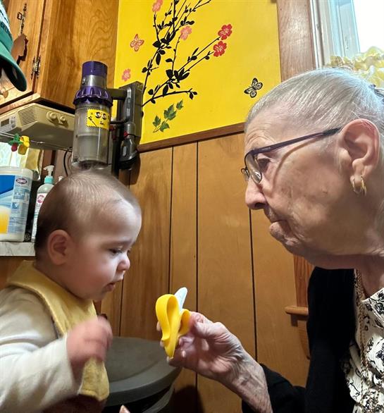 An old woman holding a baby