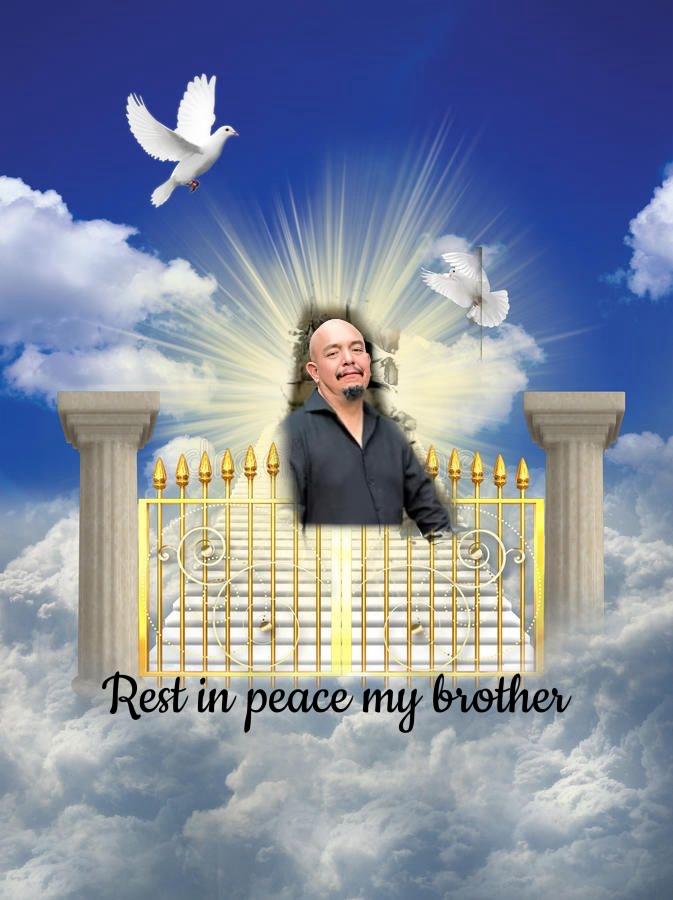 A tribute showcases a man in a black shirt surrounded by soft clouds and doves, representing peace.
