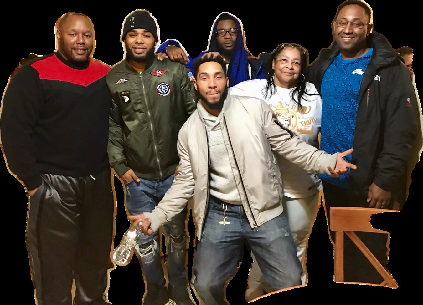 A close-knit group enjoys each other's company during a lively evening event at a local venue.