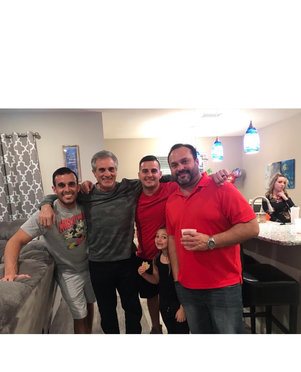 Group of family members enjoying each other's company during a lively gathering at home.
