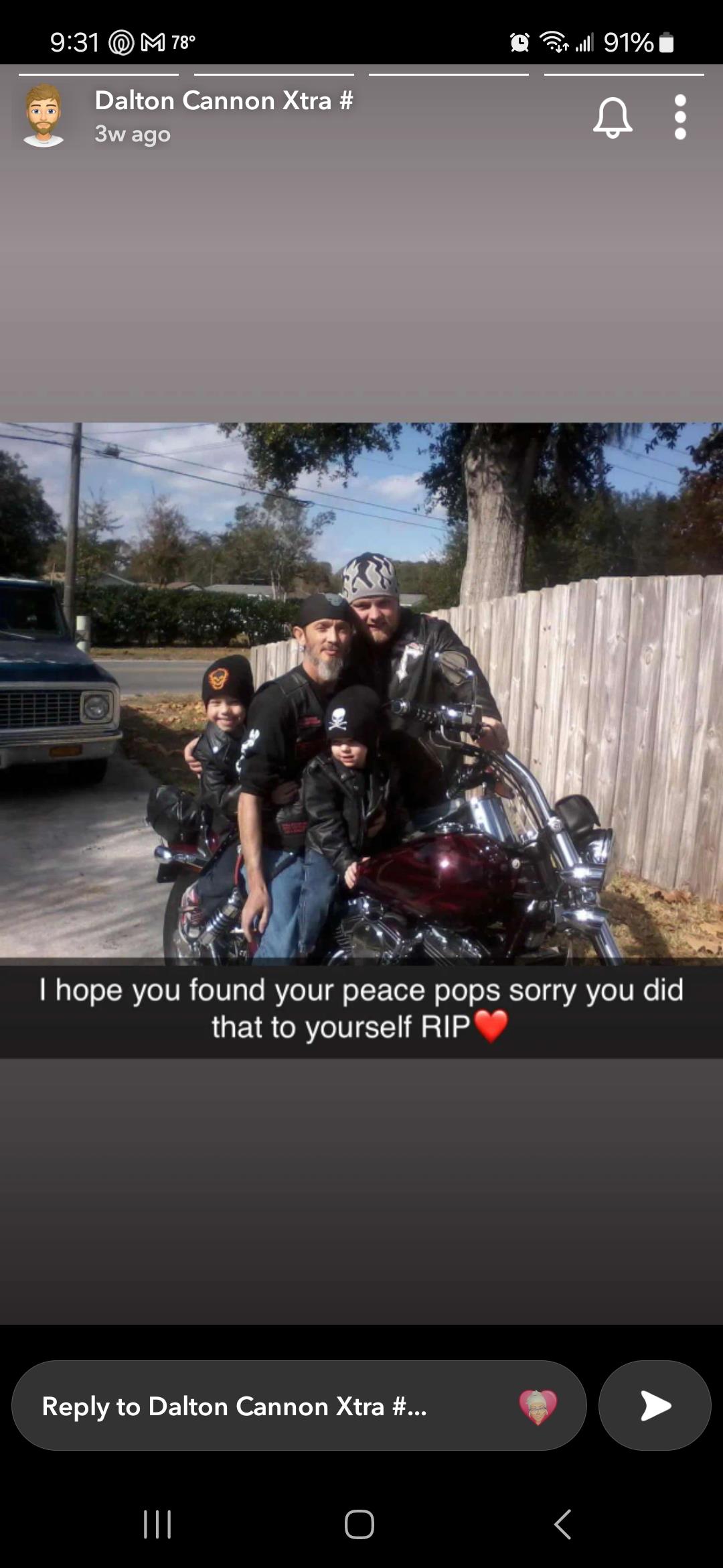 Family members gather for a photograph on a motorcycle, sharing smiles in the yard.