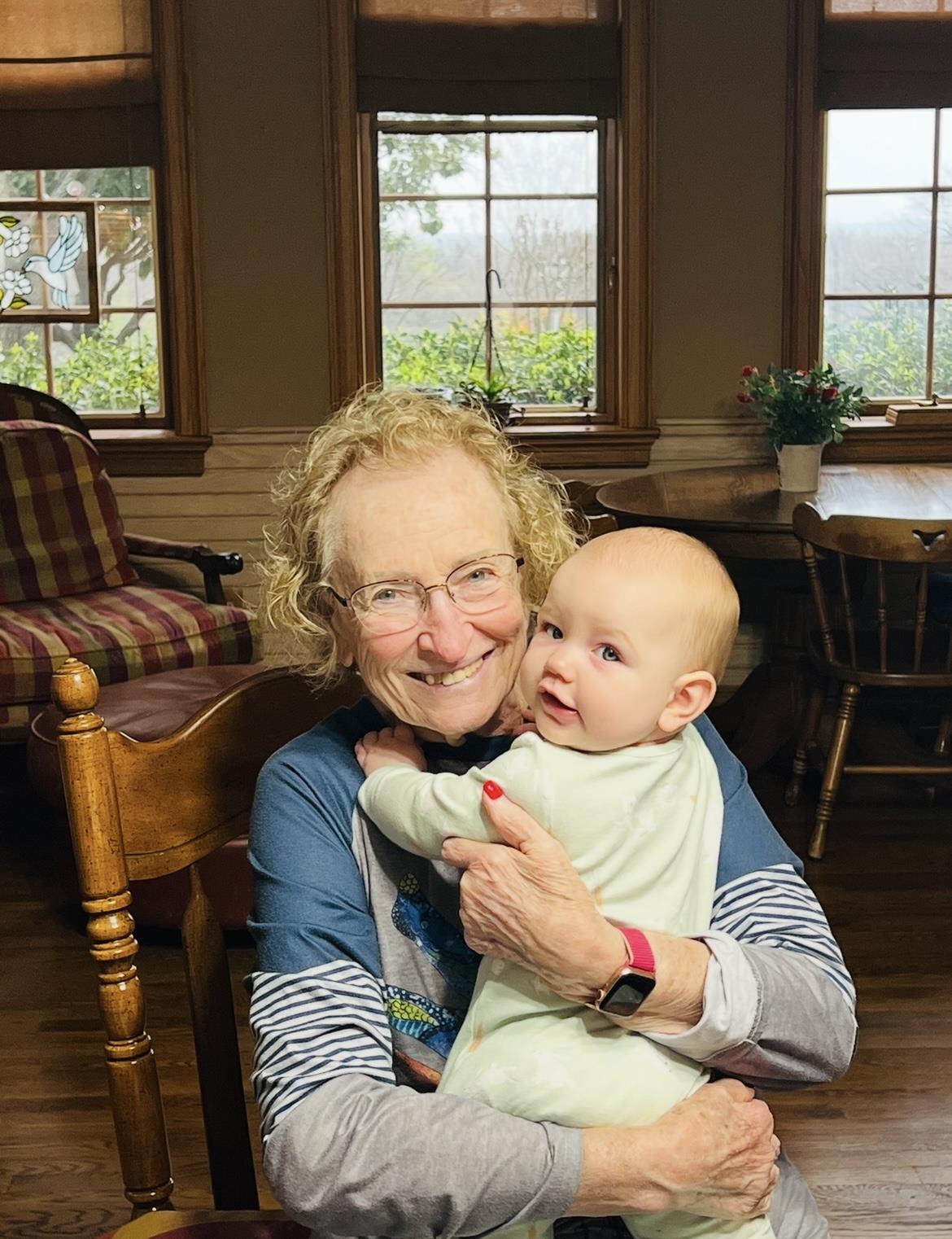 Warm moment captured in a cozy kitchen of a grandmother with her baby granddaughter.