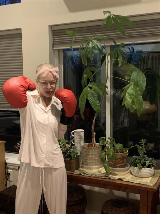 A woman wearing boxing gloves