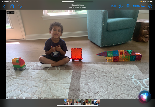 A child sitting on the floor with toys