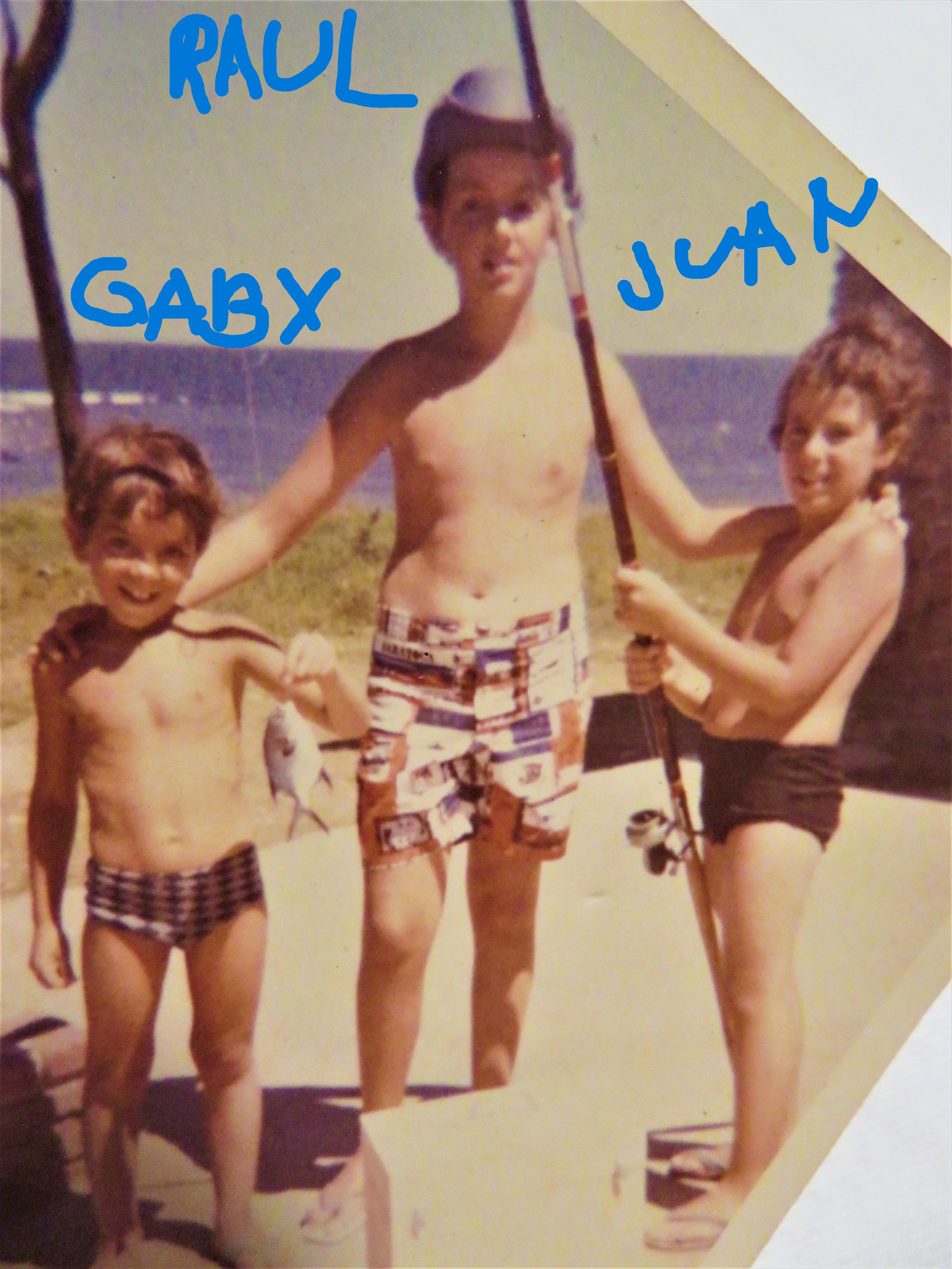 A group of boys holding fishing rods
