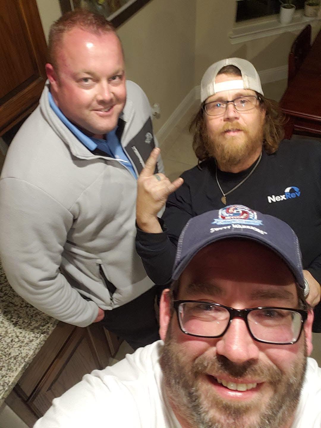 Friends bond in a warm kitchen while enjoying a relaxed evening and capturing memories.