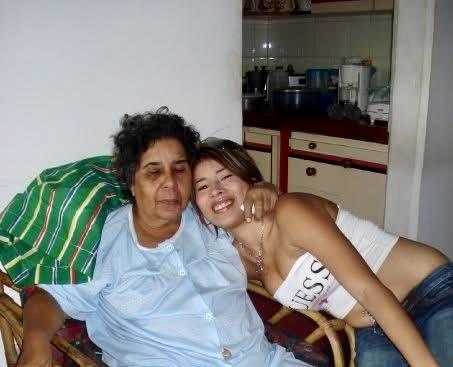 Two women share a warm embrace, enjoying quality time in a cozy home environment.