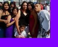 Friends gather together, laughing and posing for a cheerful group photo outdoors during festivities.