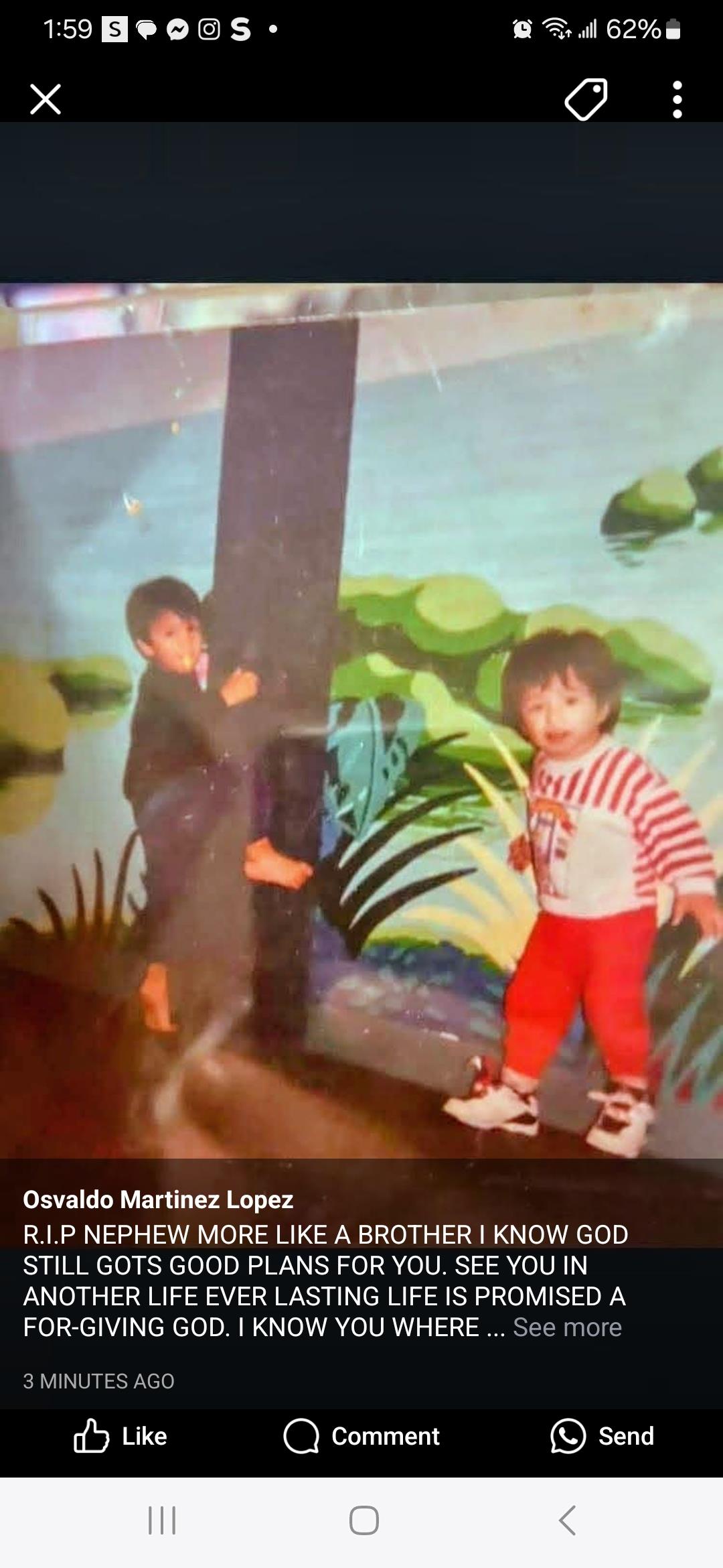 Two children engage in playful activities near a vibrant mural depicting a natural landscape.