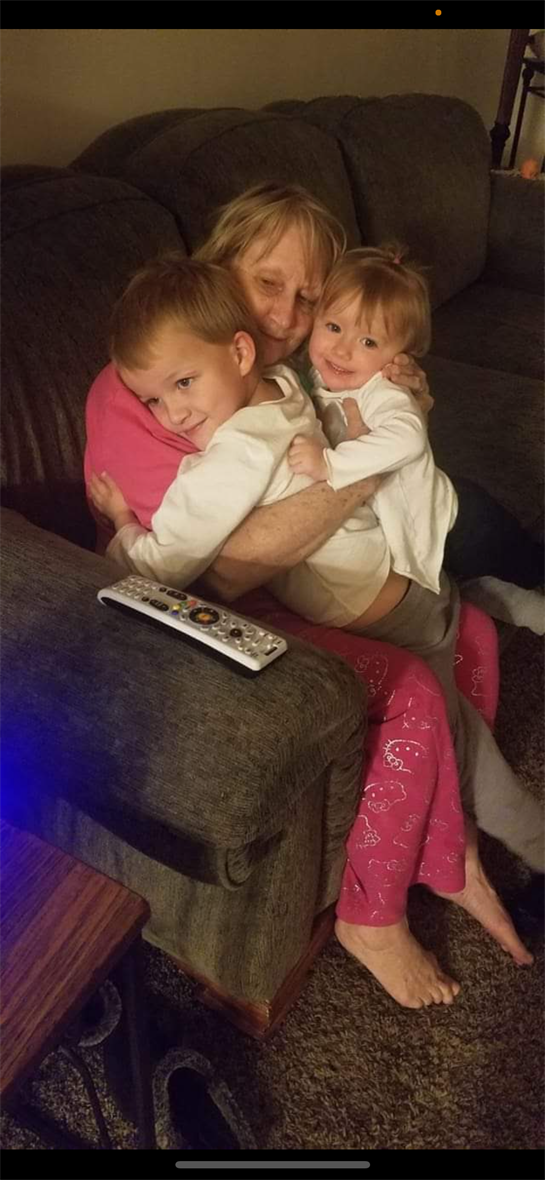 A woman holding a couple of children