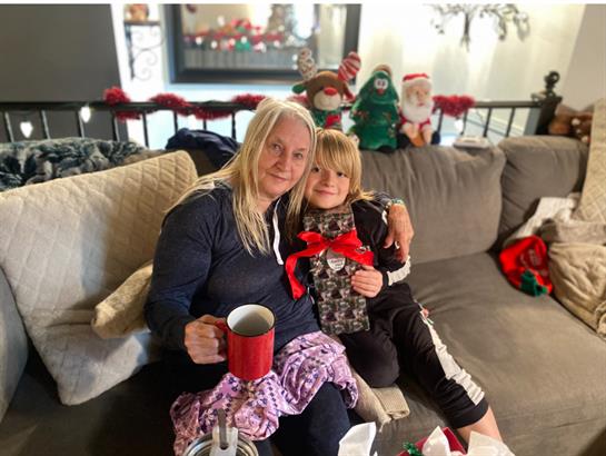A woman and child sitting on a couch