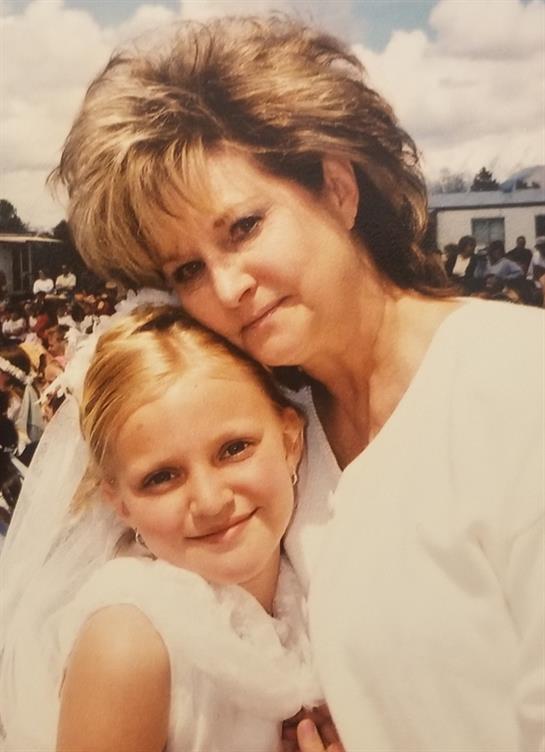 A woman and a girl posing for a picture