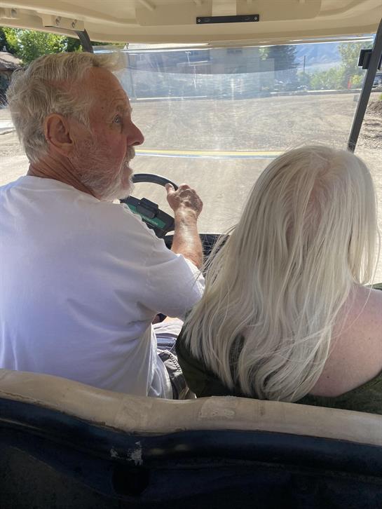 A man and woman driving a vehicle
