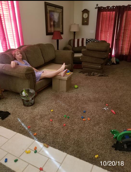 A woman lying on a couch in a living room