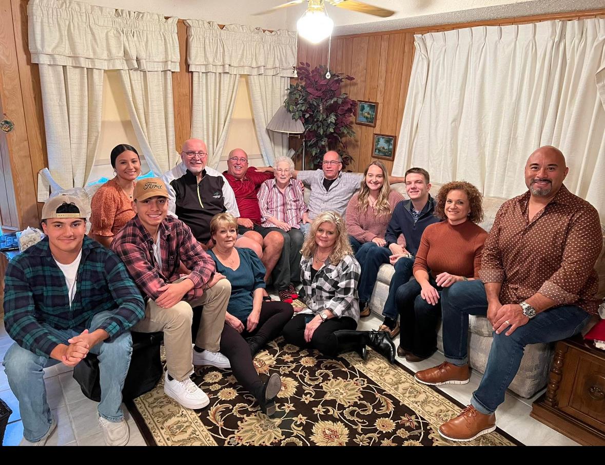 A joyful family reunion takes place in a warm, inviting living room filled with love and memories.