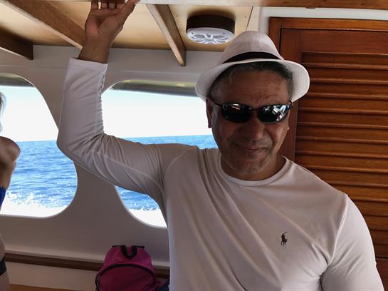 A man in a white hat and sunglasses