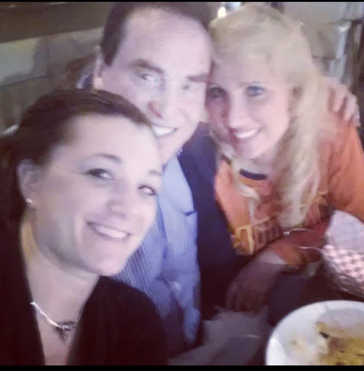 Friends share smiles and laughter at a lively restaurant, enjoying a meal together.