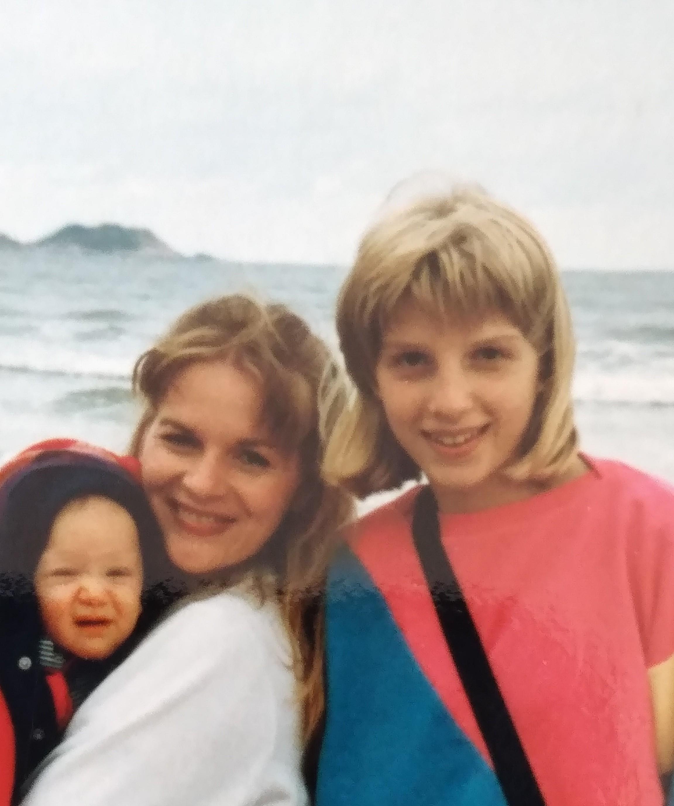 Family members spend quality time at the beach, smiling and enjoying the ocean view together.