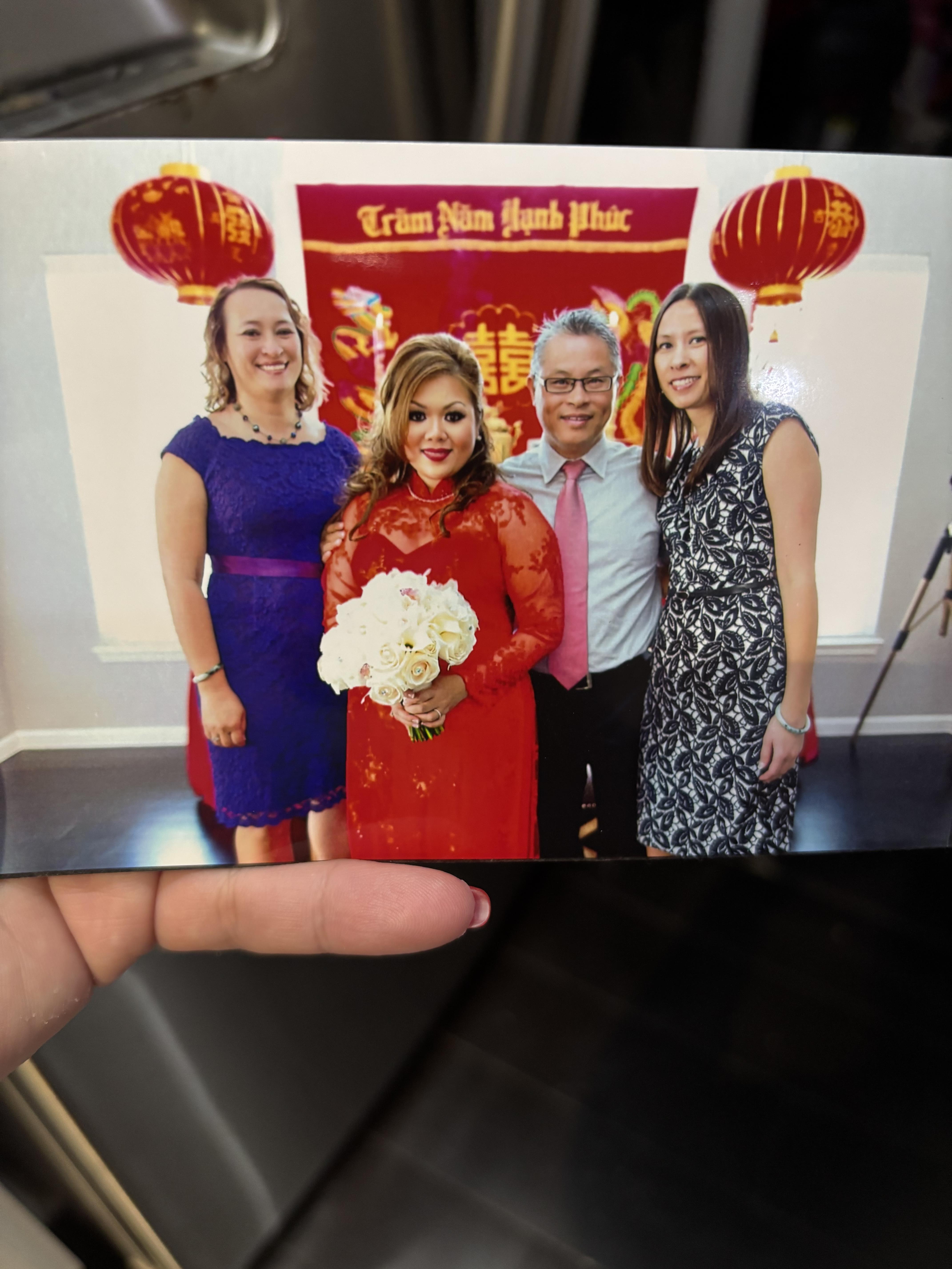 Guests gather joyfully for a traditional Vietnamese wedding celebration, dressed in colorful attire.