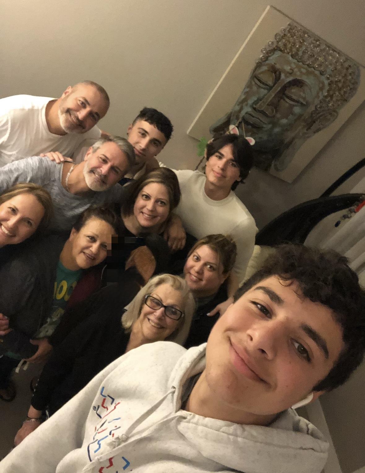 A group of family members poses together, radiating happiness in a warm, friendly atmosphere.