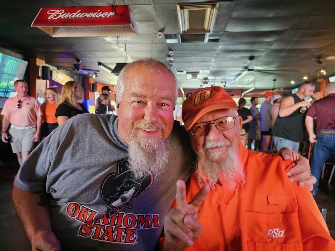 Fans enthusiastically enjoy an event at a sports bar in Oklahoma, showcasing team spirit.