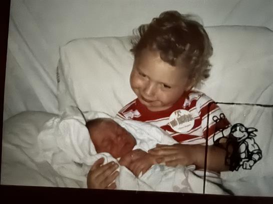 A child holding a baby