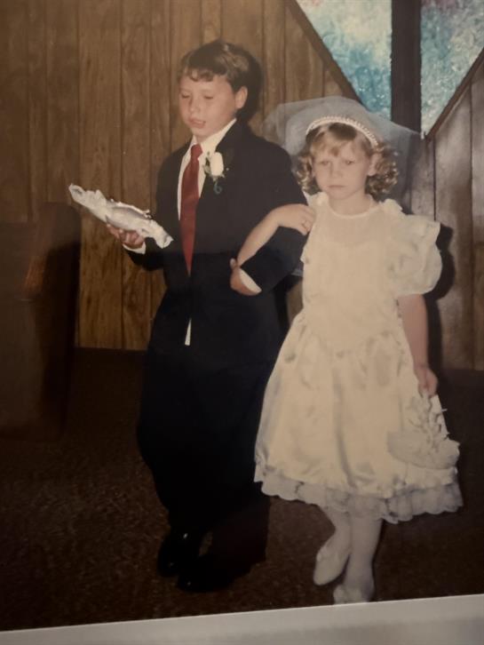 A boy and girl in wedding attire