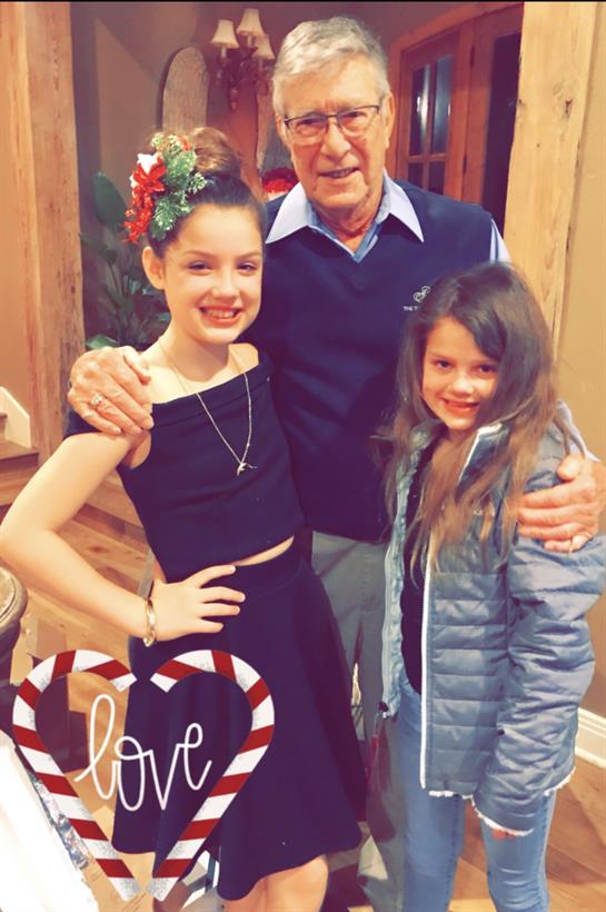 A man and two girls posing for a picture