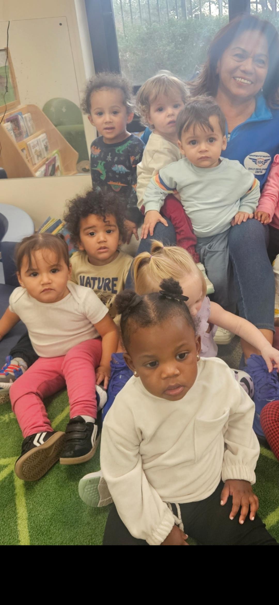 Young children participate in a fun and interactive session at a daycare, engaging with peers.