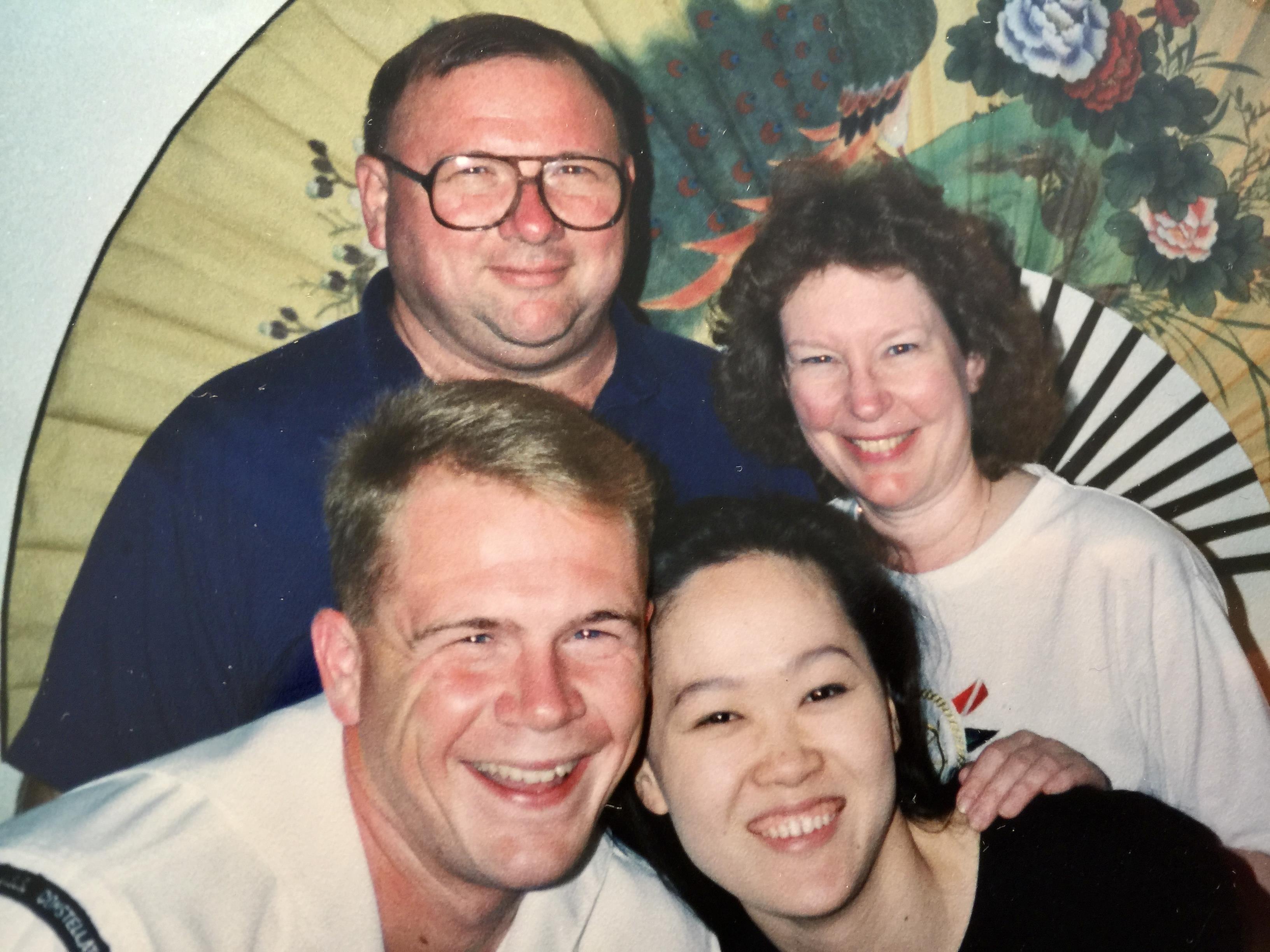 Four friends gather for a cheerful moment, showcasing their happiness at a lively event.