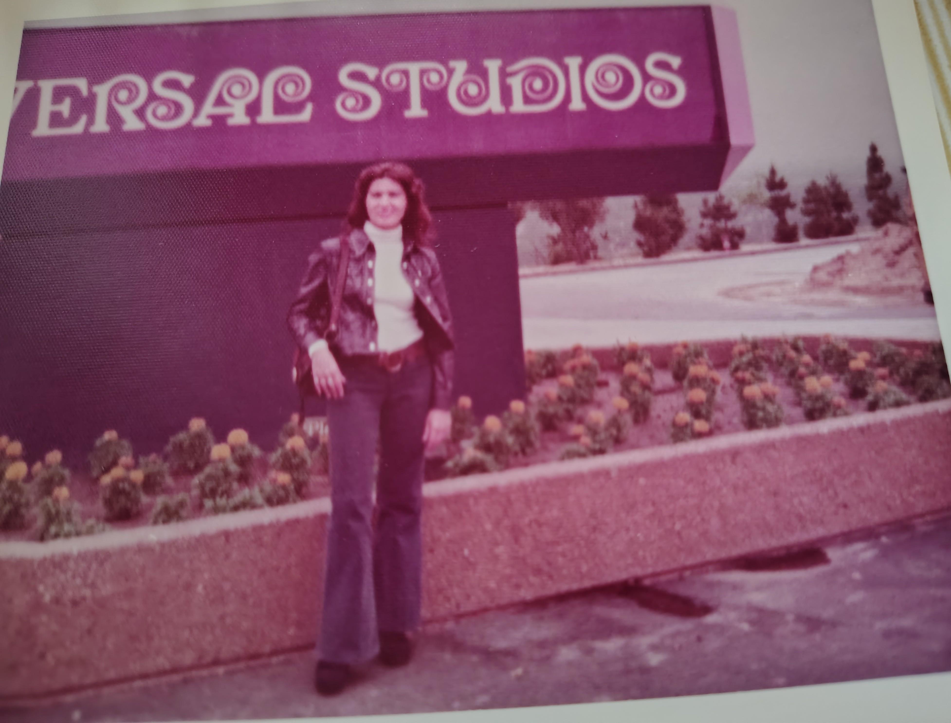 A woman standing in front of a sign