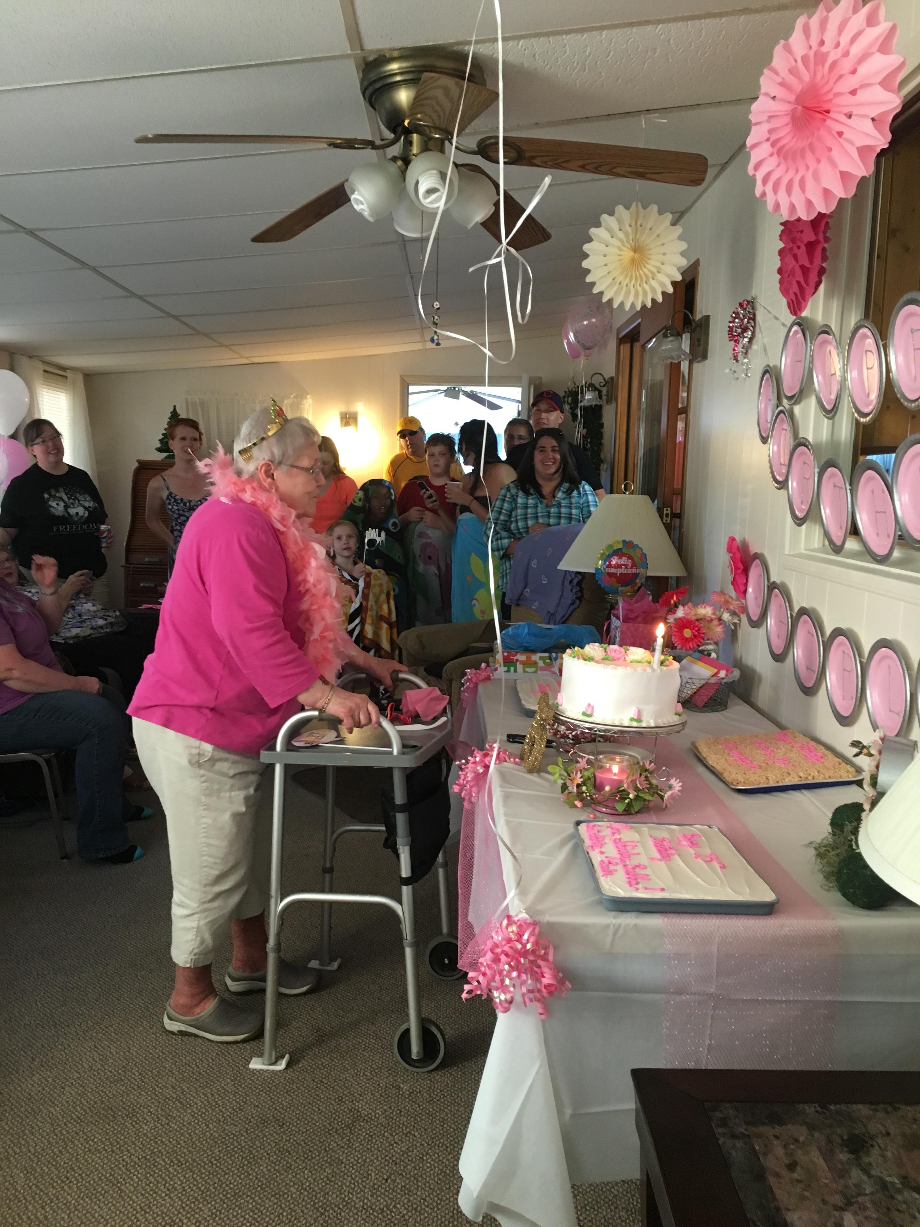 Guests come together in a cozy room to celebrate a joyful birthday with laughter and love.