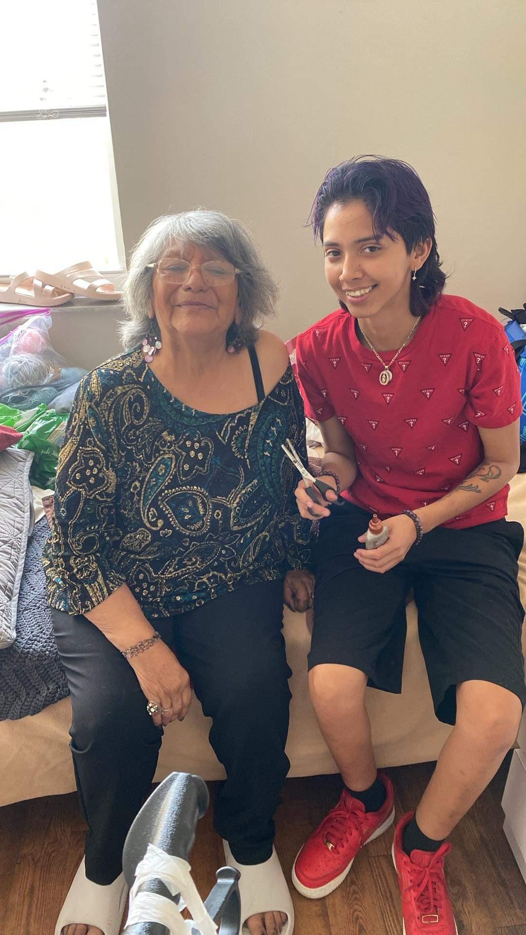 Two individuals sit together, smiling and enjoying a moment of connection while getting ready.