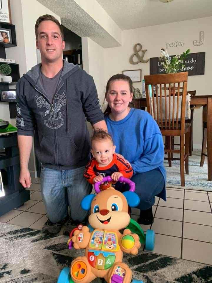 Loving parents engage with their toddler in a warm family setting filled with joy and laughter.