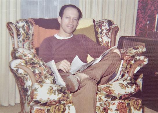 A man sitting in a chair with a newspaper