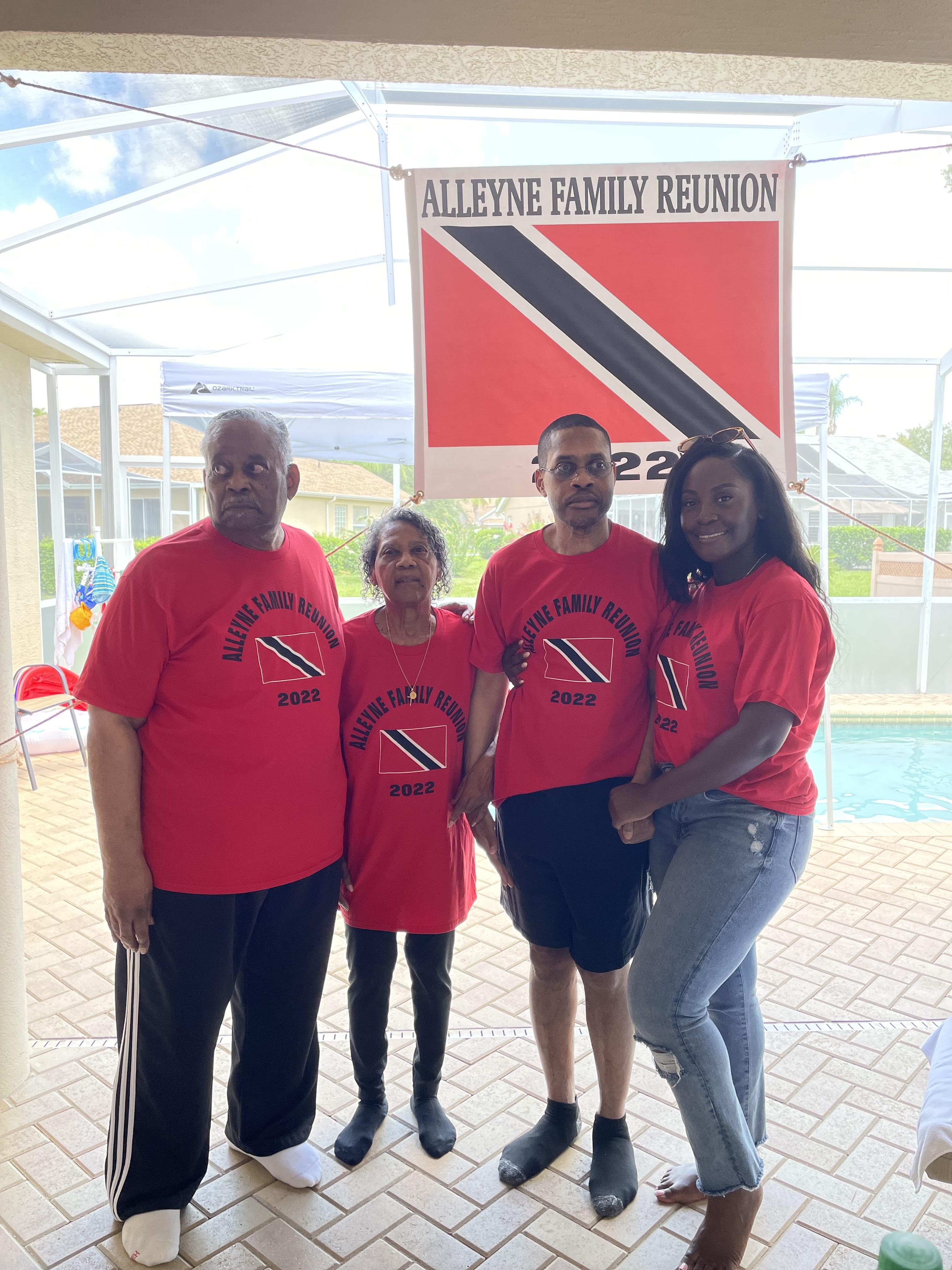 Family members celebrate their reunion by the pool wearing matching shirts and smiling together.