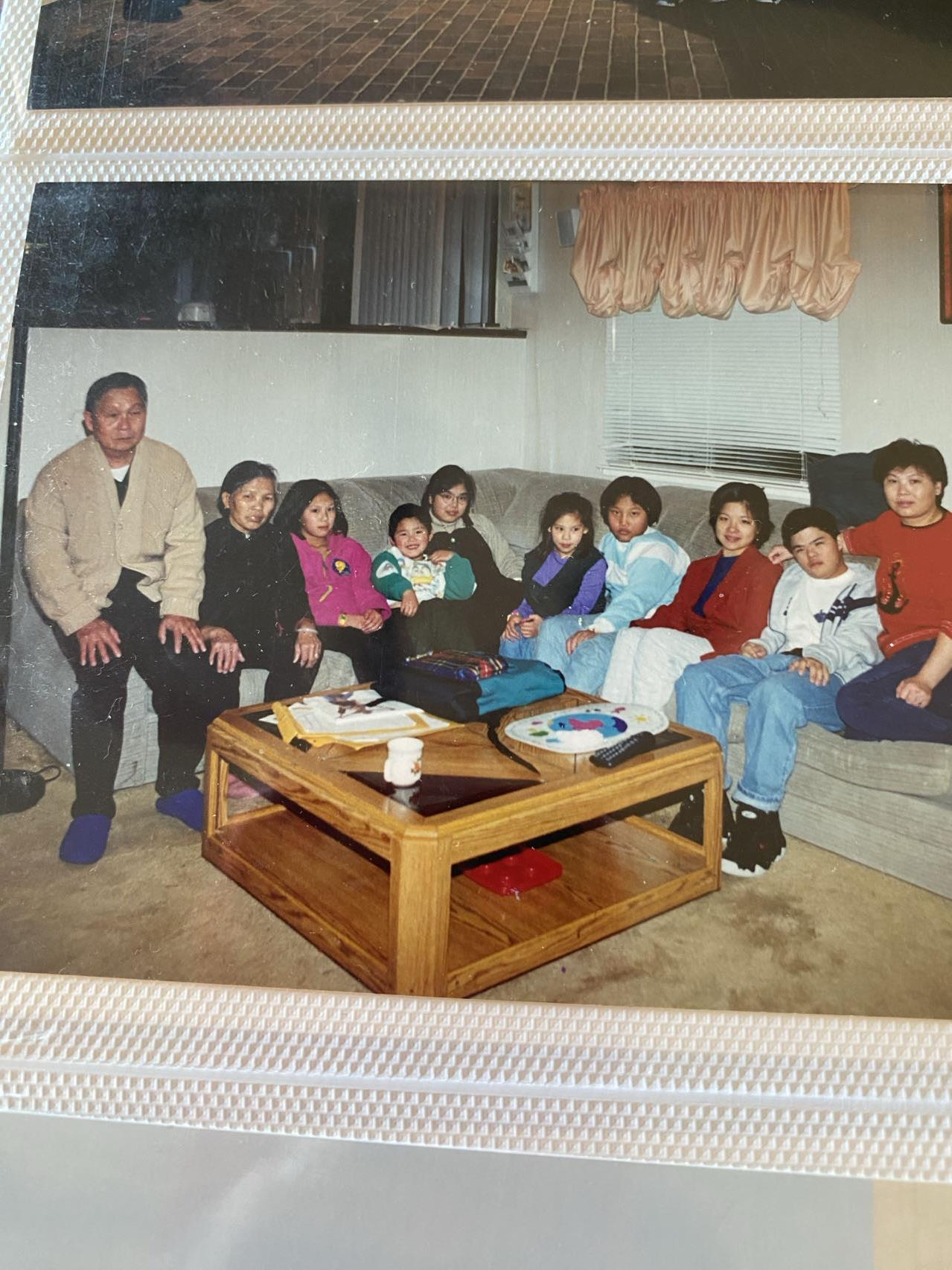 A group of family members sits in a cozy living room, sharing laughter and stories while relaxing.