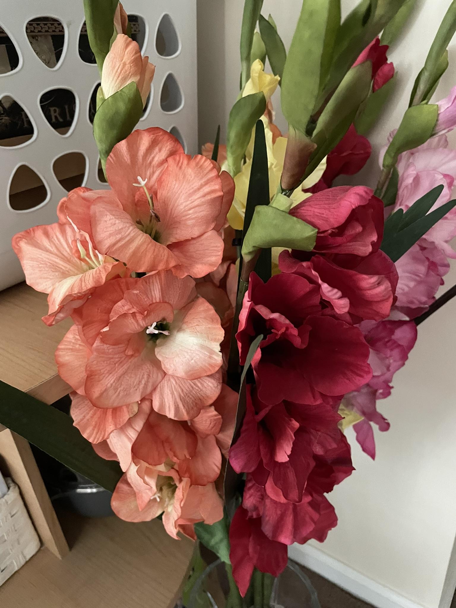 Beautifully arranged flowers in shades of orange and red create a lively atmosphere indoors.