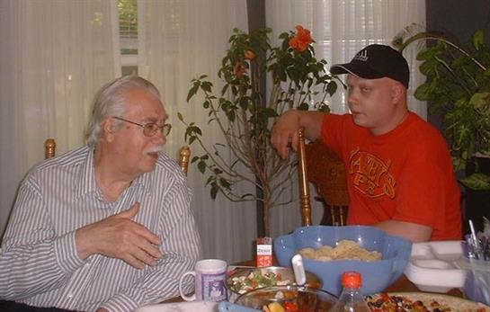 A man and boy sitting at a table
