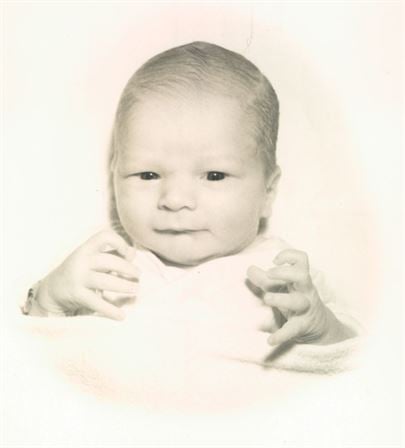 A baby with hands in front of it