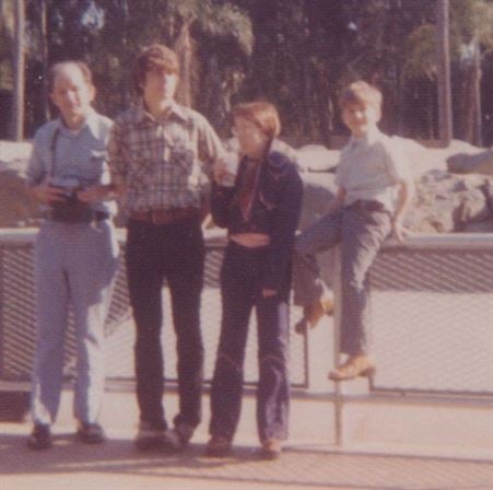 A group of people standing on a railing