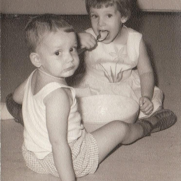 Two young kids engage in playful interaction, enjoying their time in a friendly atmosphere.